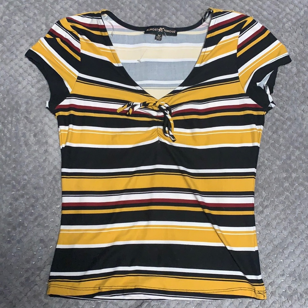 Yellow, Black, Red, and White Top